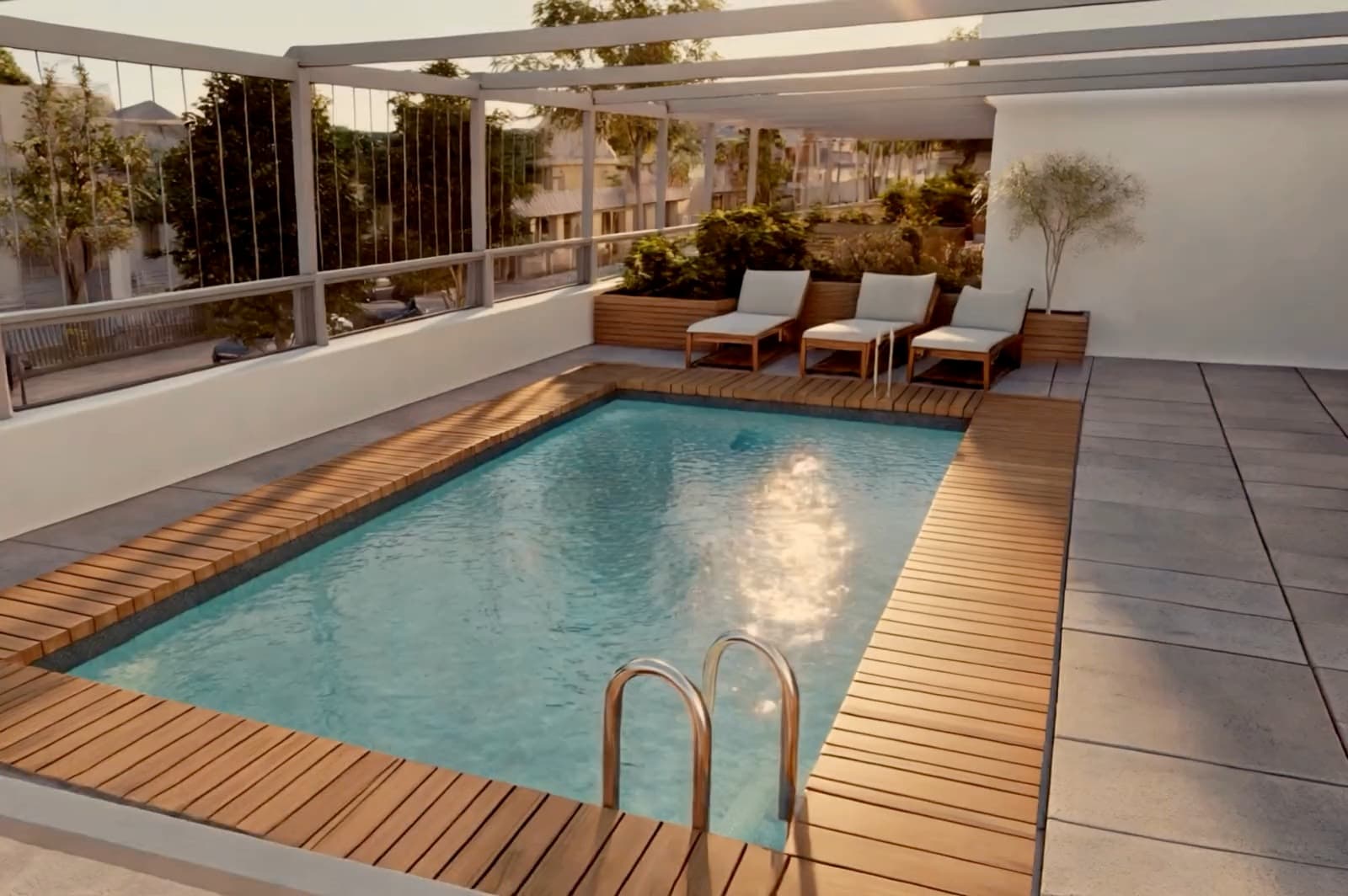 Piscina en la azotea de Jacarandá vista desde arriba, con la luz dorada del atardecer